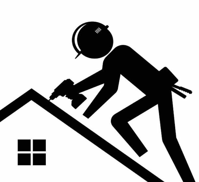Roofer in a helmet on the roof doing repairs and service